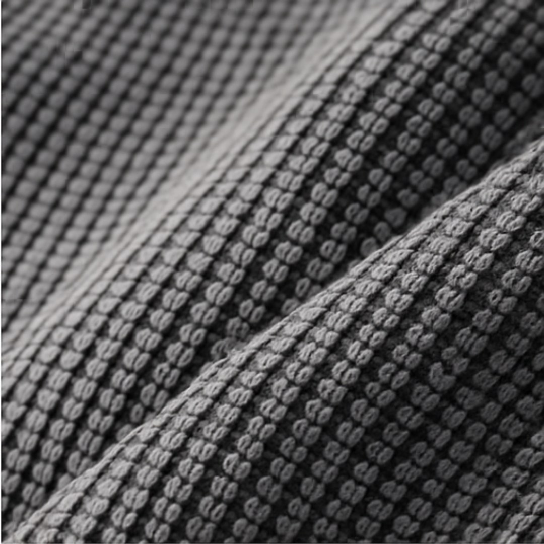 Close-up of textured gray fabric with a waffle pattern